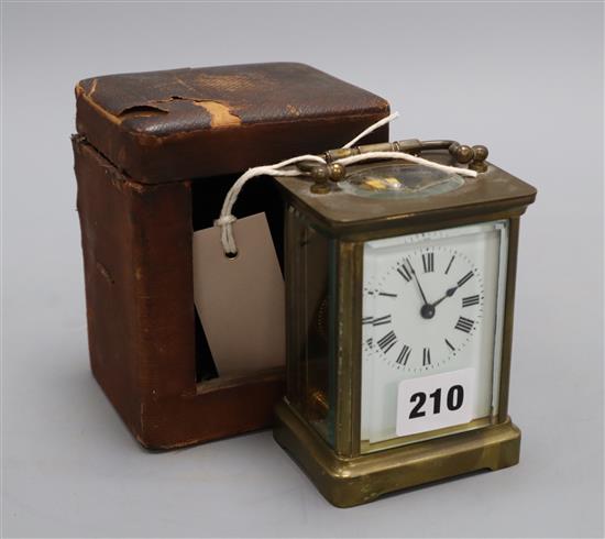 A brass mounted carriage timepiece and case